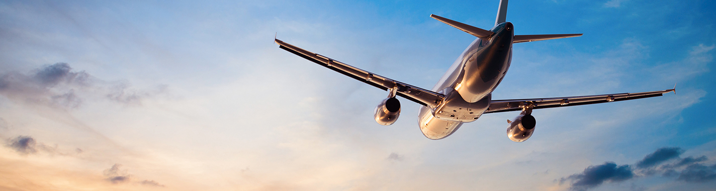 airplane flying at sunset