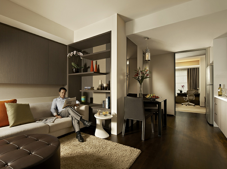 Man lounging on sofa serviced residence