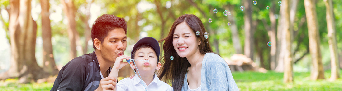 Asian family blowing bubbles