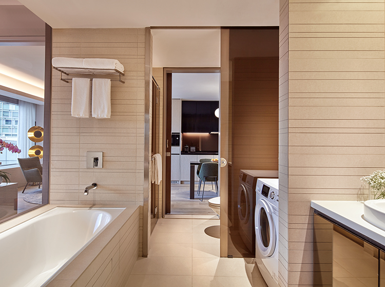 toilet with washing machine in the serviced suite