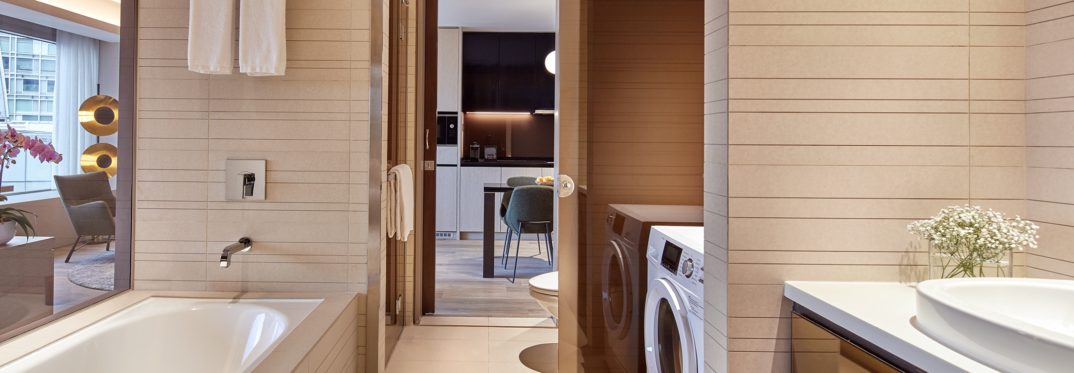 toilet with washing machine in the serviced suite