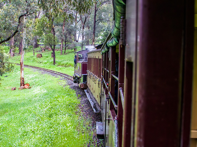old steam train crossing a bridge