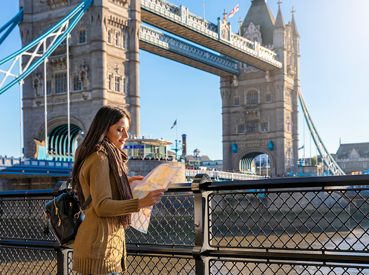 lady traveller in front of tower bridge london