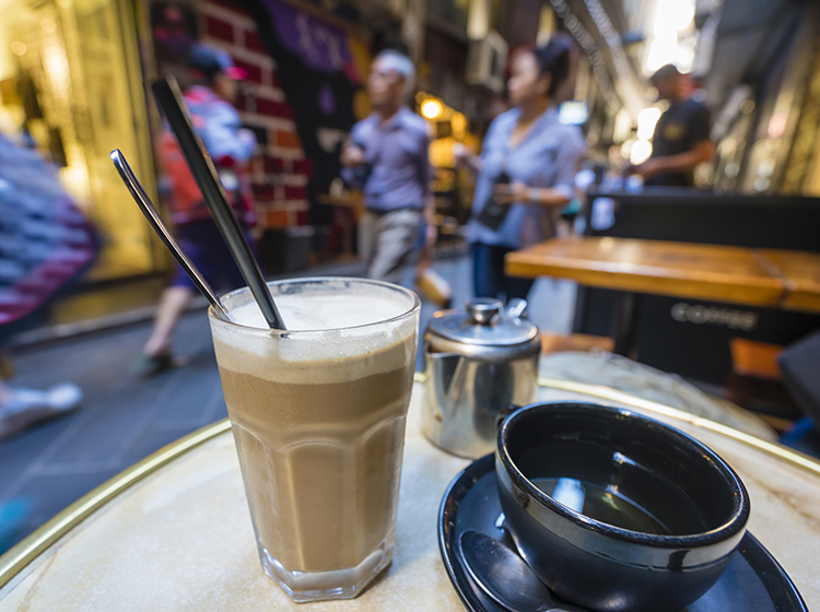 enjoying coffee in a laneway