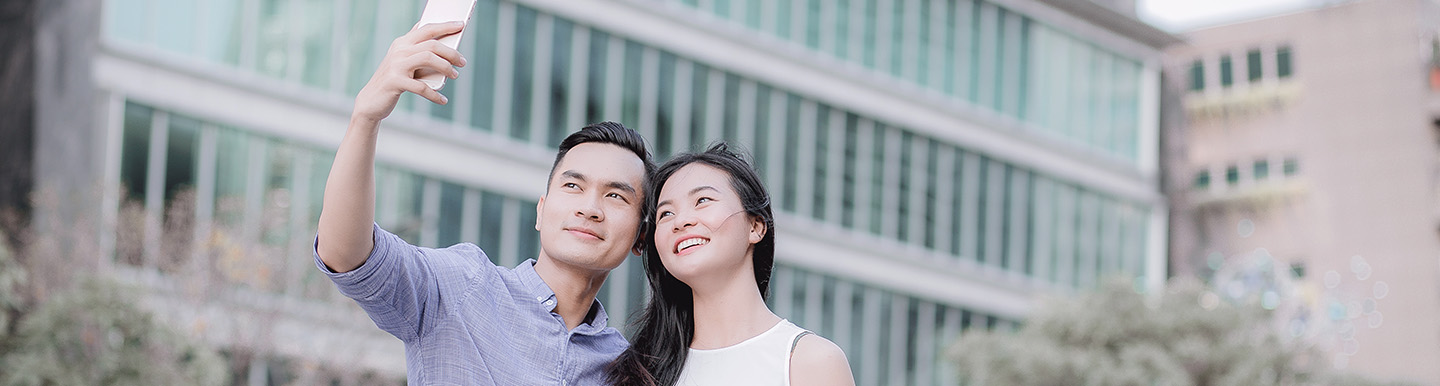 Young Asian couple taking a photo